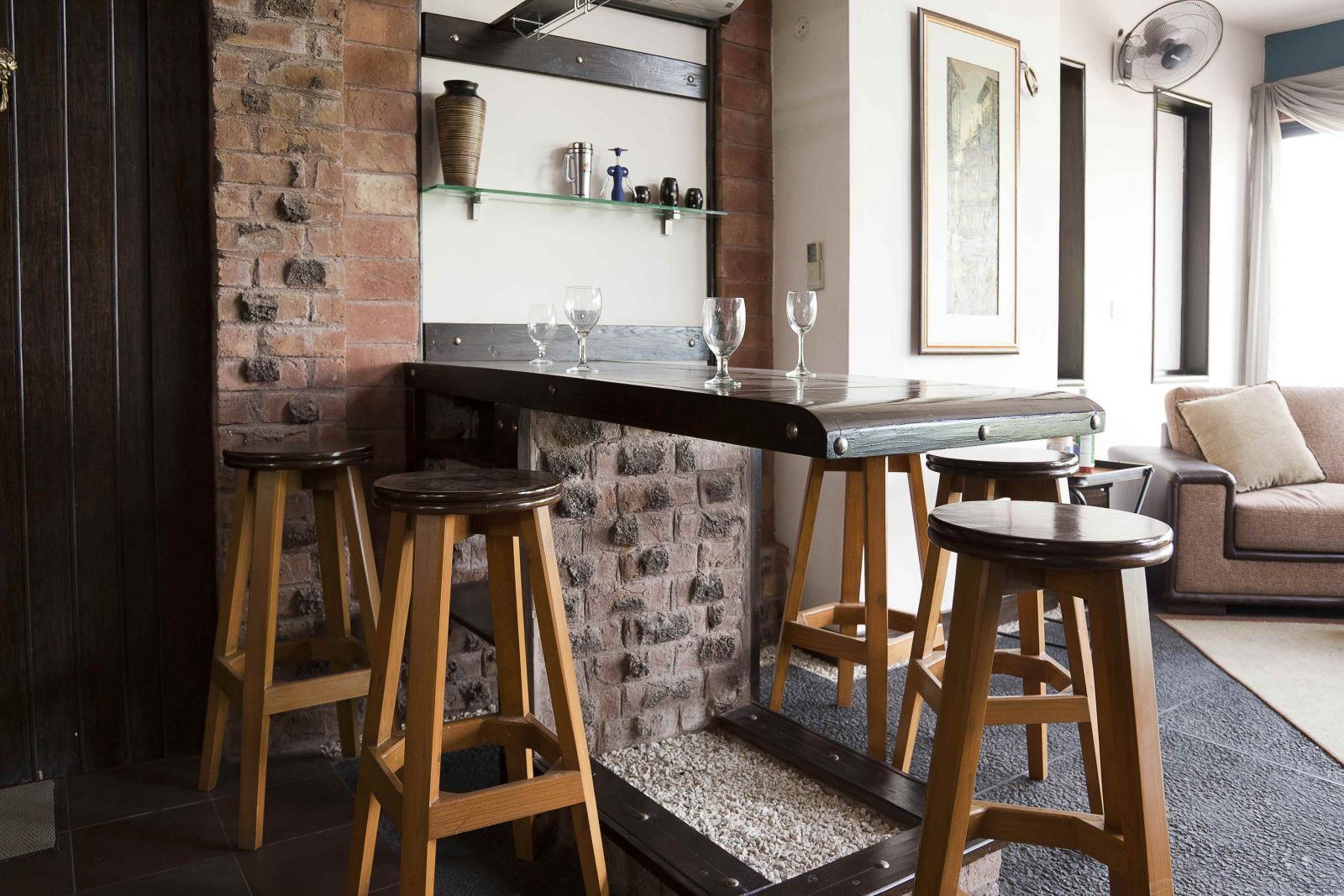 Белая и кирпичная стены в интерьере гостиной-кухни в стиле лофт