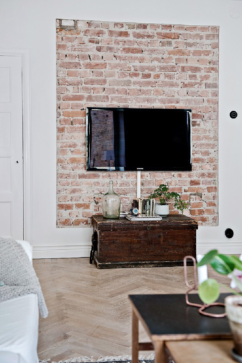 one-room Scandinavian apartment brick TV wall