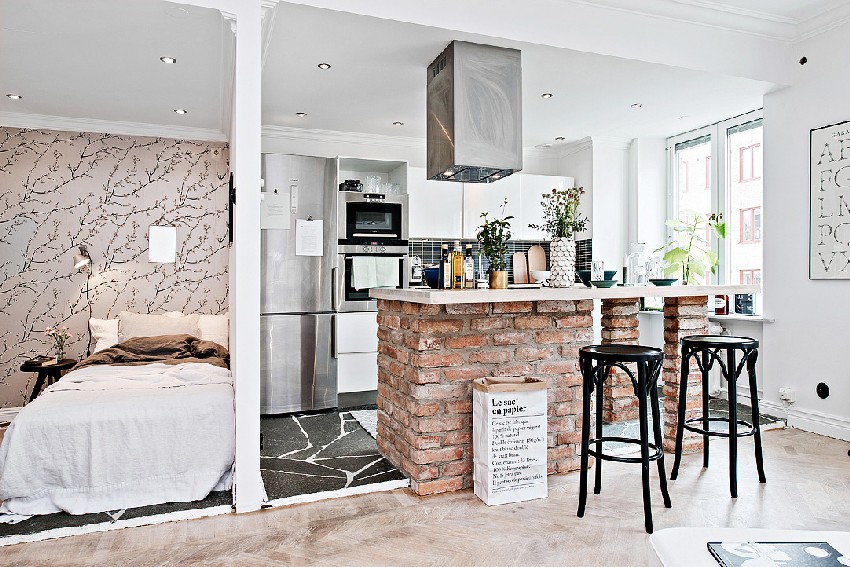 one-room Scandinavian apartment kitchen and sleeping area wall