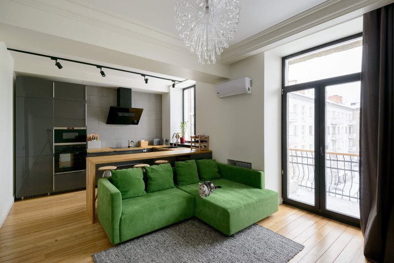 Зеленый угловой диван в кухне-гостиной