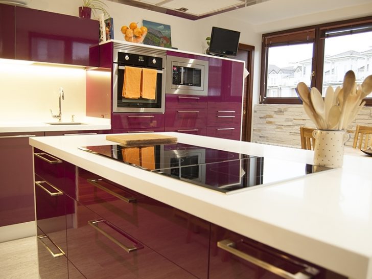 A kitchen of a bright eggplant color