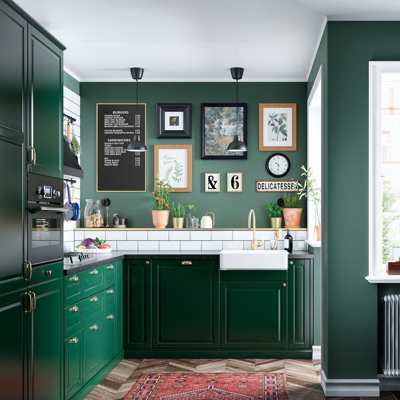 A kitchen with colour coordinated storage, lots of worktops, a cooker and sink and some frames pictures on the wall.